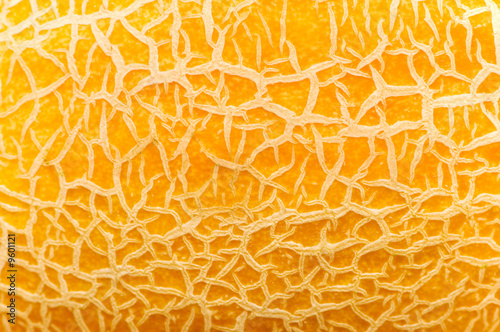 Textured yellow melon background - extreme close up photo