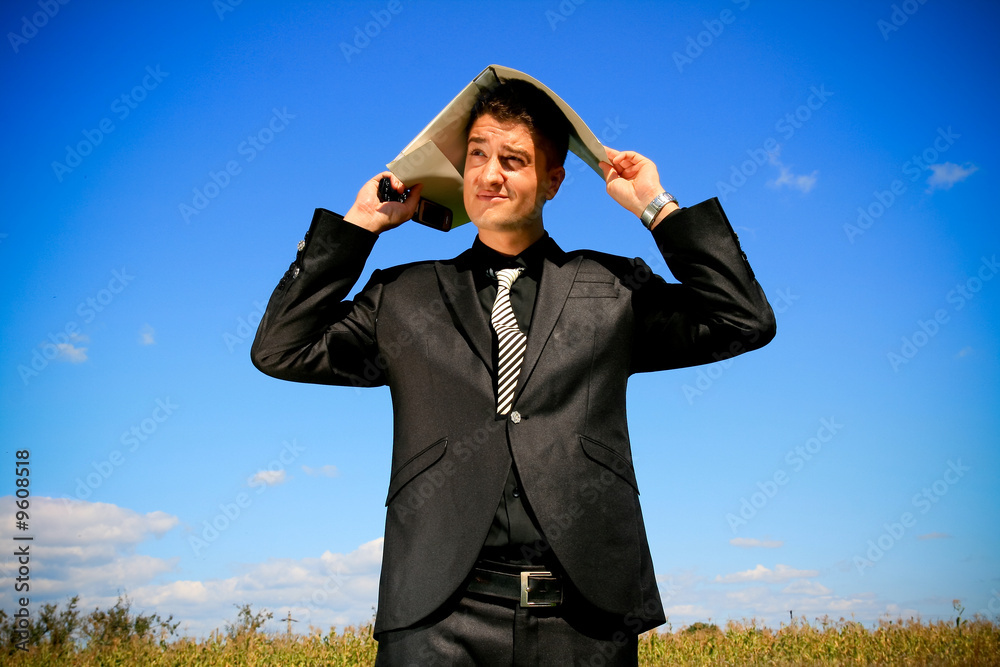 Elegant business person holding a folder and cellphone. Elegant business person holding a folder and cellphone.