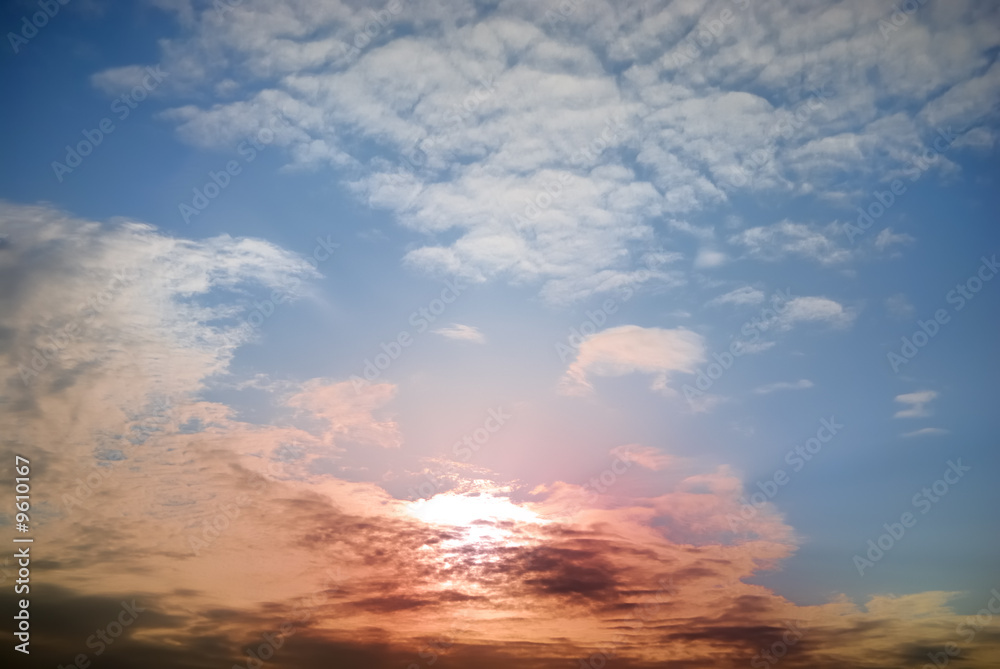 colourful sunset is in relief clouds and dark blue sky