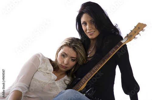 two female freinds sitting on the floor on a white background