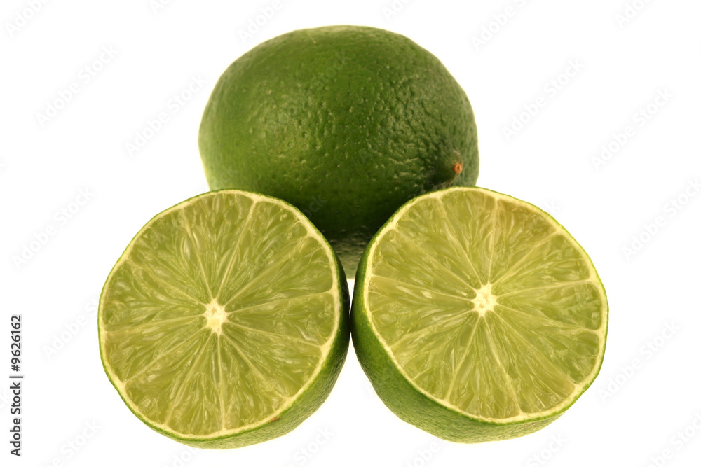 A green lime and slices isolated on a white background A green lime and slices isolated on a white background