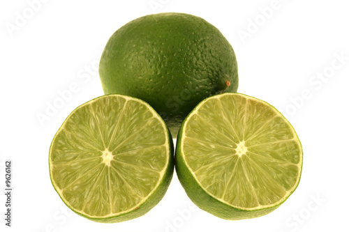 A green lime and slices isolated on a white background