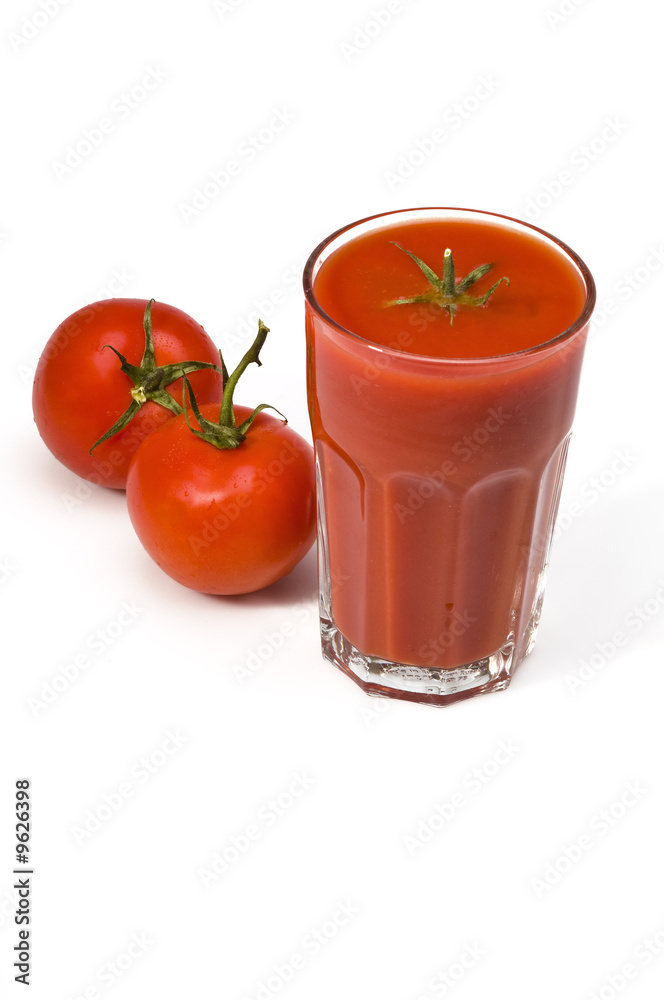 Studio shot of glass with fresh tomato juice and two tomatoes Studio shot of glass with fresh tomato juice and two tomatoes