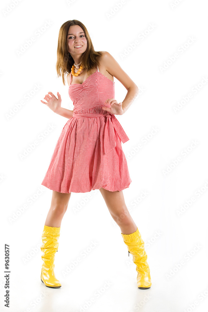 Young woman in yellow boots and checked dress Young woman in yellow boots and checked dress