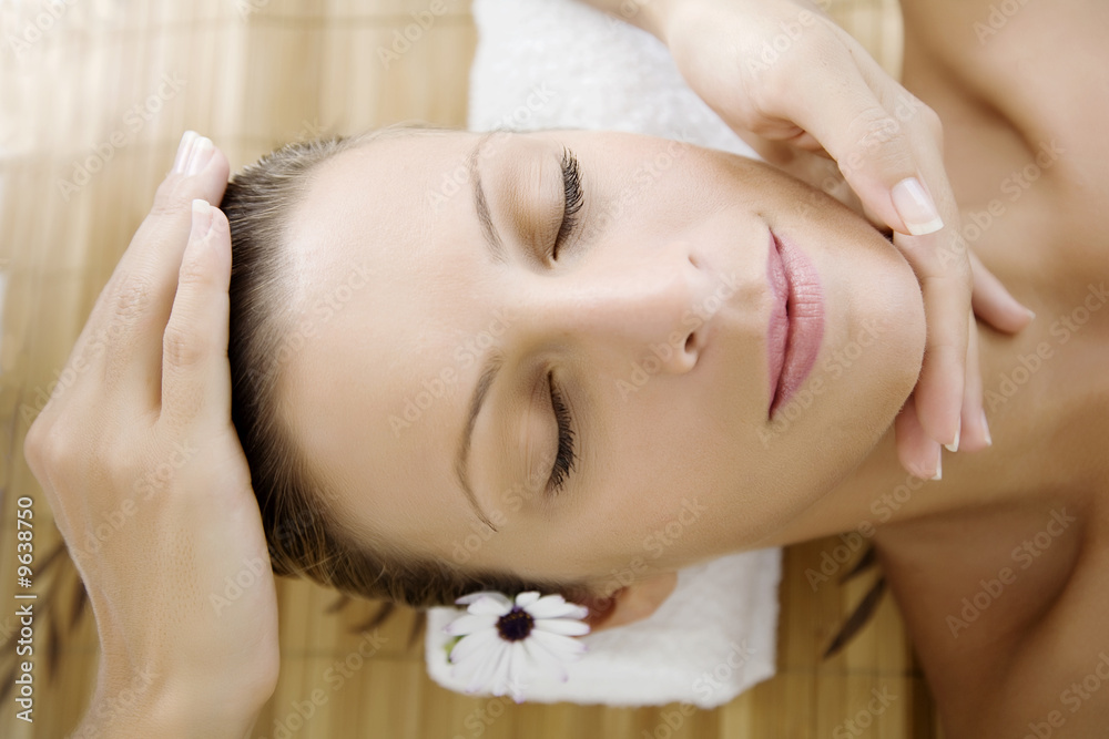 young female enjoying a facial massage or healing