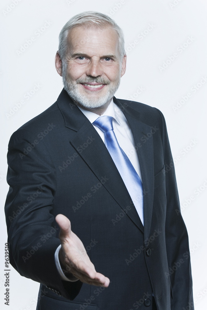 welcoming handsome senior businessman