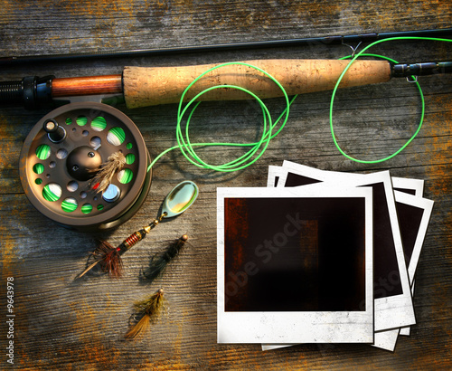Fly fishing rod with pictures on wood background