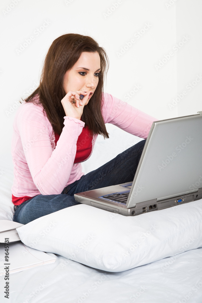 A caucasian college student studying on her laptop A caucasian college student studying on her laptop
