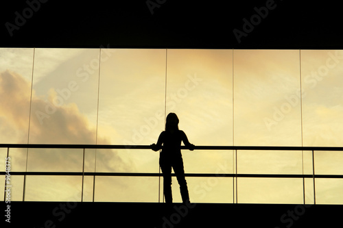woman in the modern buildind at sunset photo