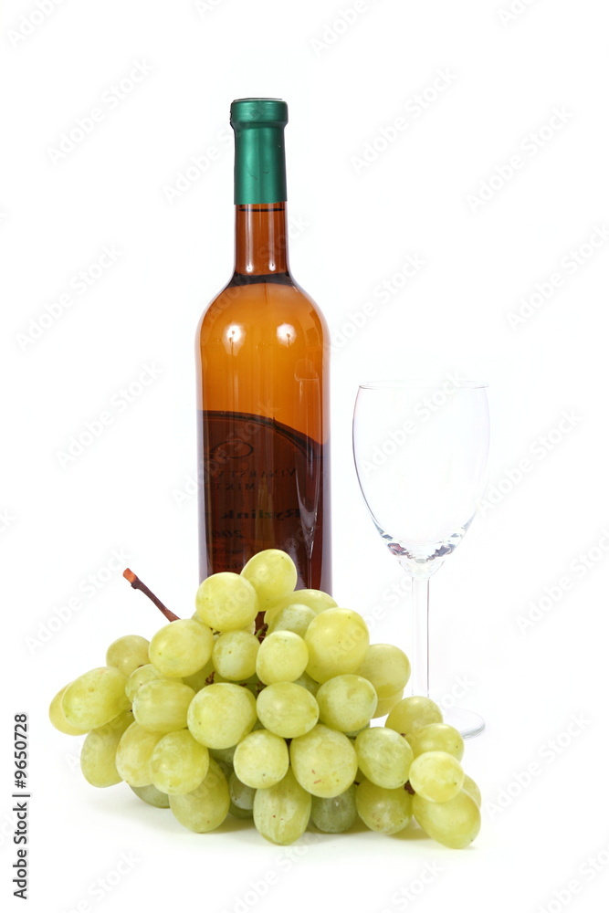 Bottle of white wine and glass with grapes on white background