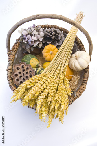 Wicker basket with autumn fruit and vegetables, isolated