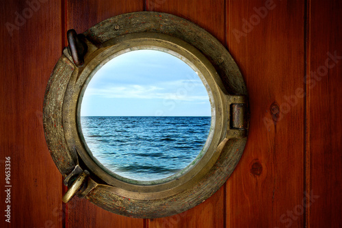 Close-up of a boat closed porthole with ocean view