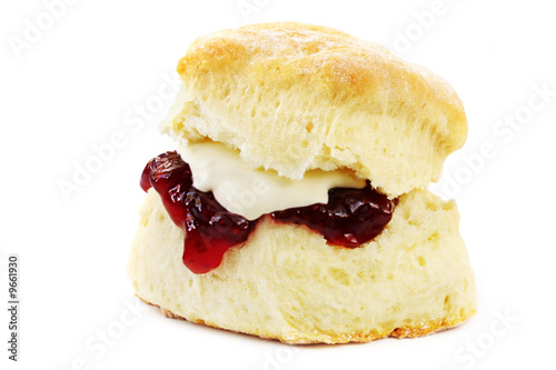 Fresh-baked scone, with strawberry jam and whipped cream.