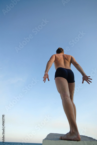 young  man on  background of  dark blue sky