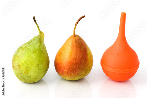 Two pears and a rubber siringe suggesting evolution process