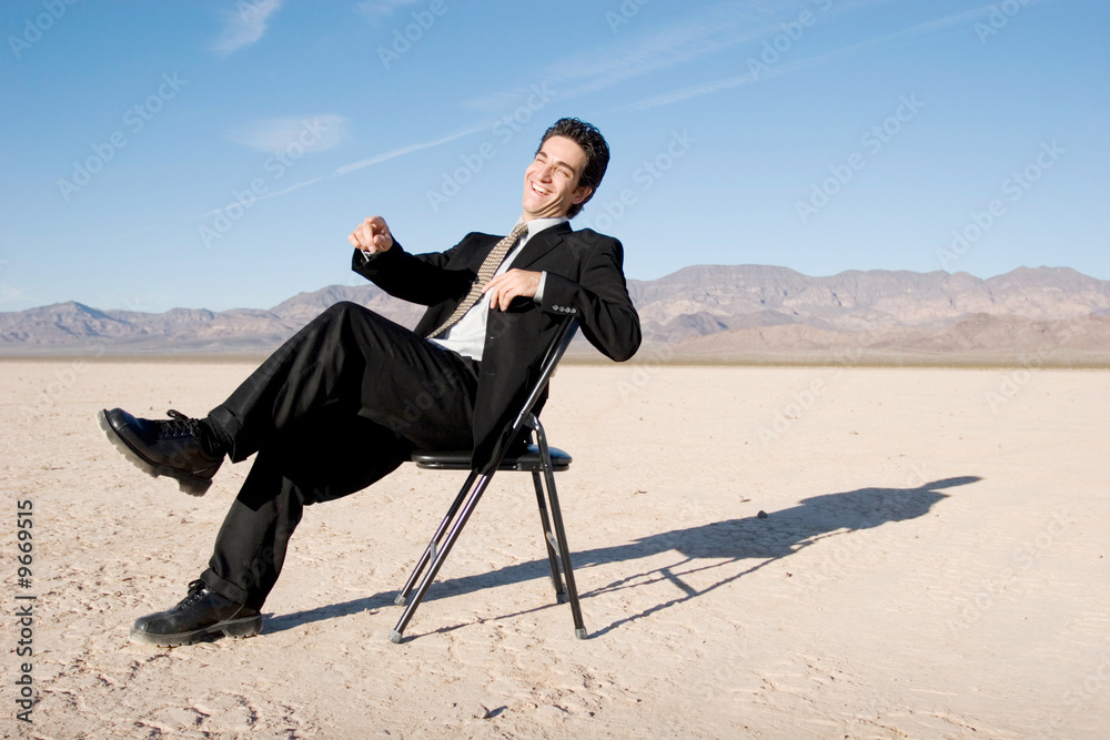 Smiling businessman sitting on a chair Smiling businessman sitting on a chair