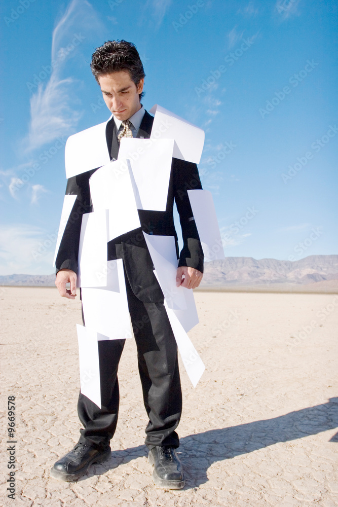 Businessman covered with white papers Businessman covered with white papers