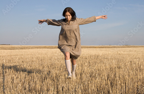 girl running on the field in sunny day