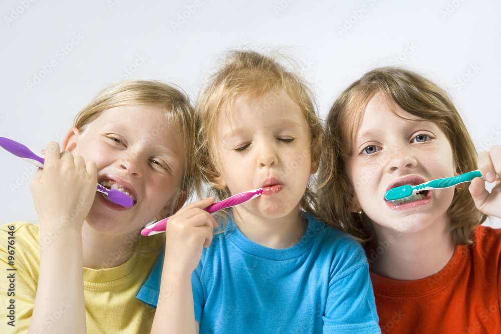 Little girl wearing colorful t-shirts brushing teeth Little girl wearing colorful t-shirts brushing teeth