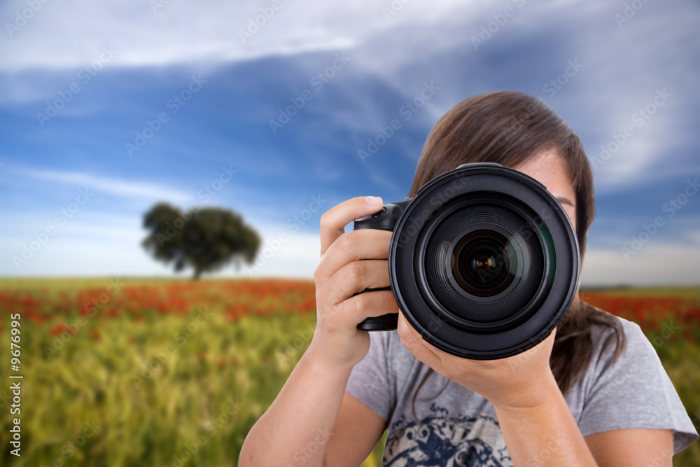 young woman with landscape as background taking photos young woman with landscape as background taking photos