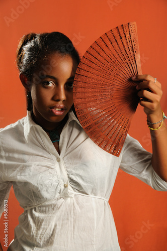 Portrait of trendy african fashion girl with fan