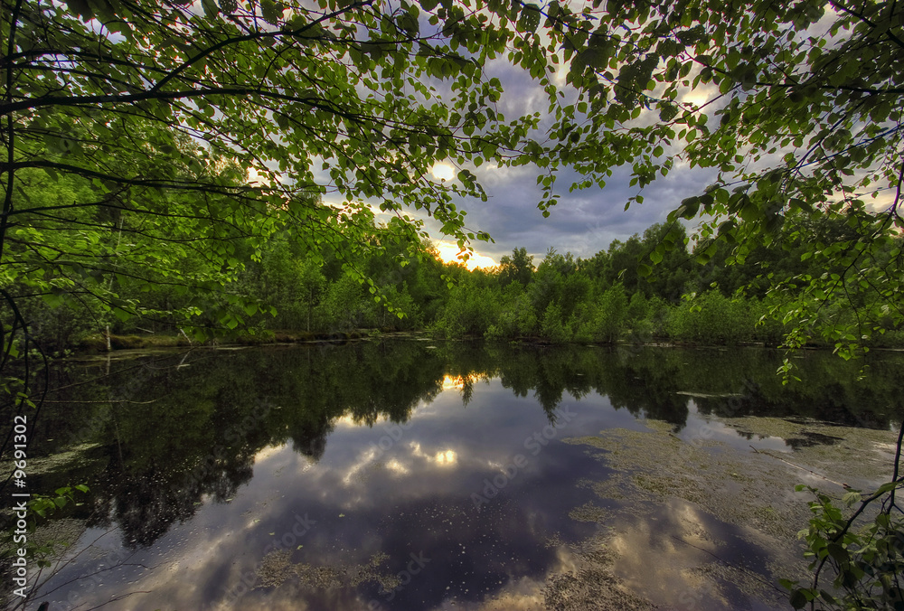 Gloomy sunset above lake