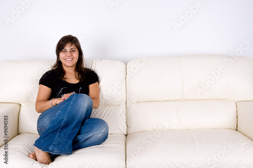 beautiful young woman with black shirt sitting in white sofa