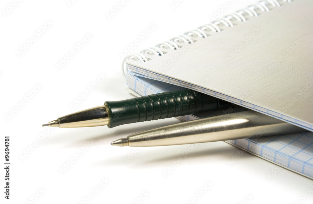 blank notebook and two pens closeup blank notebook and two pens closeup