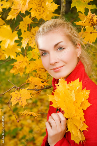 Beautiful young woman in atumn forest