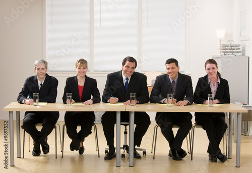 Panel of co-workers about to conduct a job interview