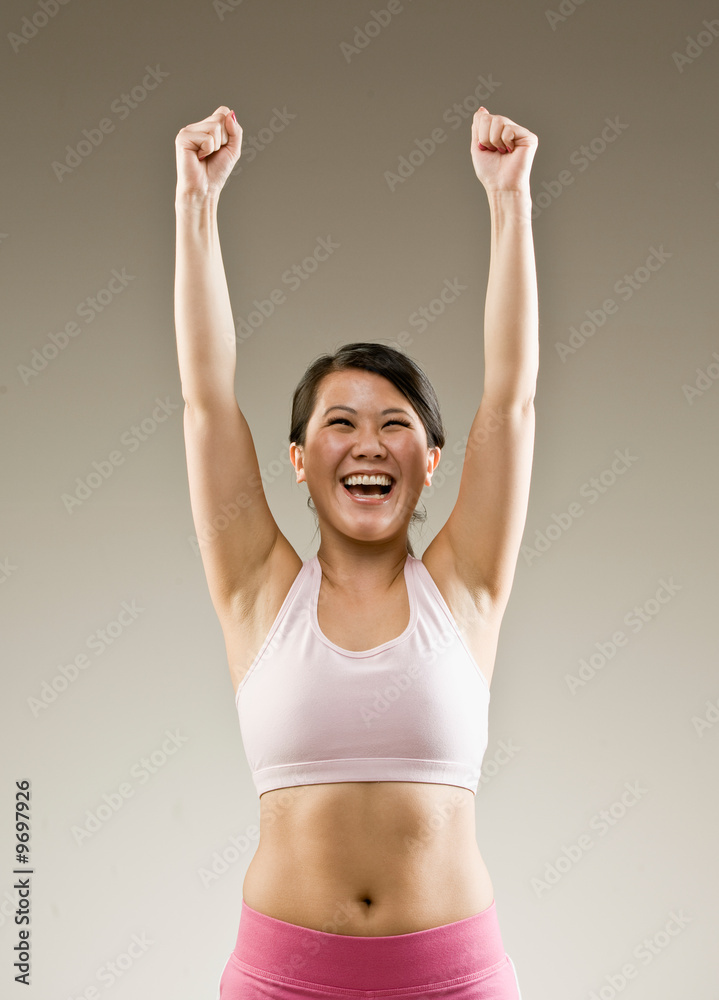 Woman in sportswear cheering and celebrating her success