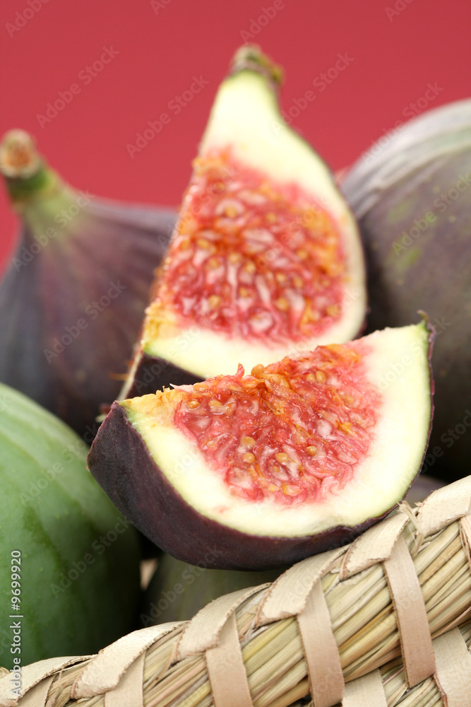 basket of fresh figs on red background - food and drink basket of fresh figs on red background - food and drink