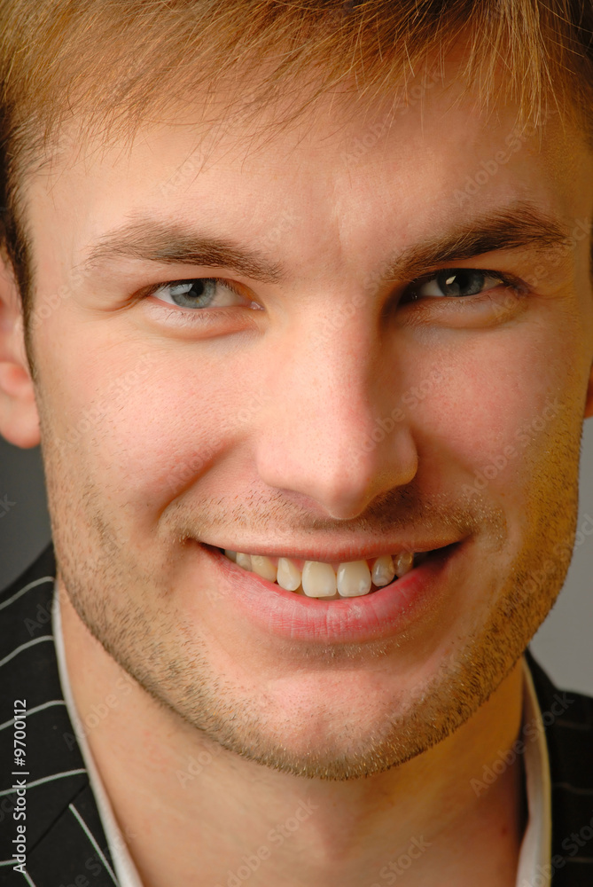 Fototapeta premium Portrait smiling young businessman, close up