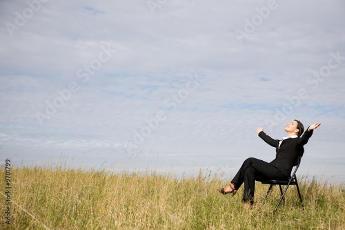 attractive brunette businesswoman relaxing on meadow © Adam Borkowski