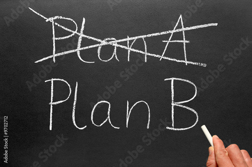Crossing out Plan A and writing Plan B on a blackboard.