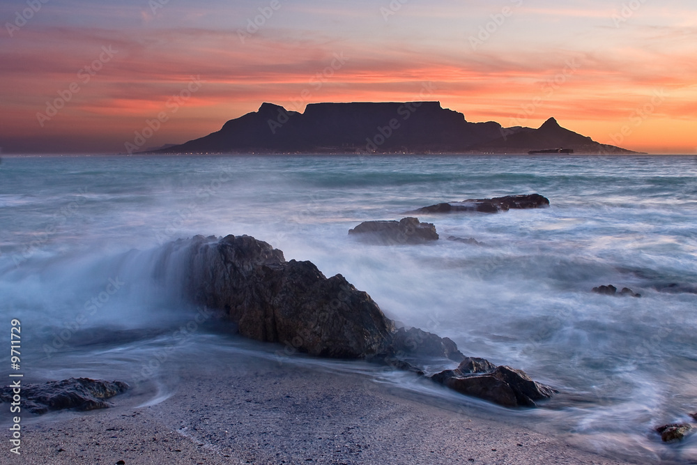 The colors of Table Mountain at sunset with large rocks