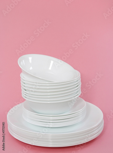 Photos white dishes stacked, pink background