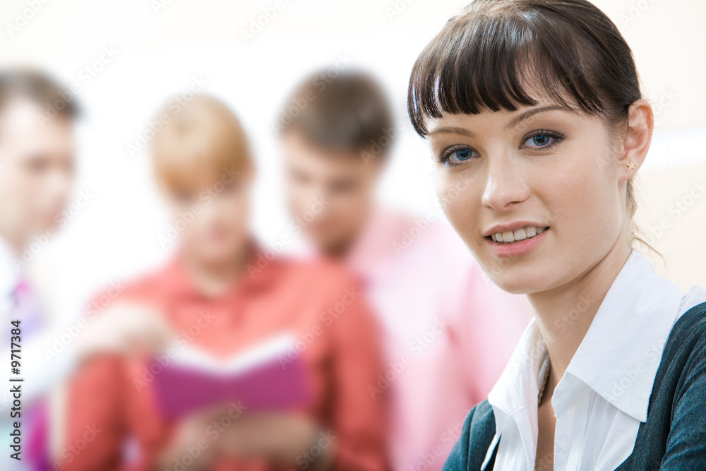 Face of young employee looking at camera with smile Face of young employee looking at camera with smile