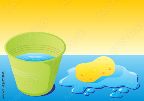 Green bucket with water and sponge with water splash