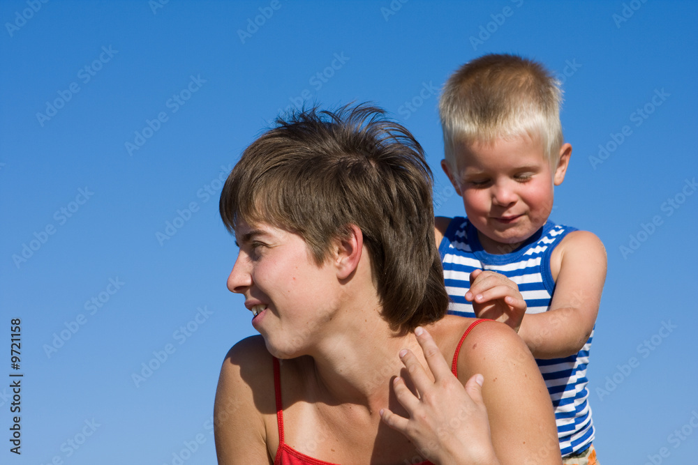 Mother and son on blue sky background Mother and son on blue sky background