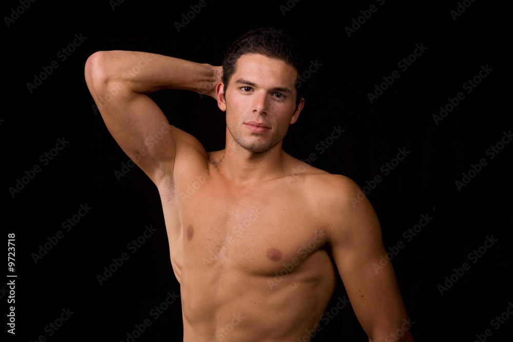 young sensual man on a black background
