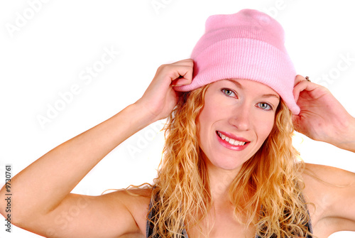 Young attractive woman trying on a pink wool hat
