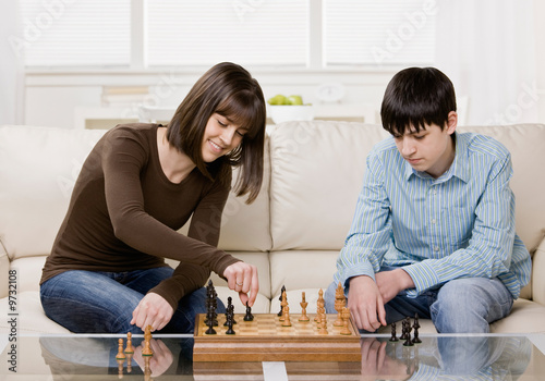 Friends playing chess in livingroom