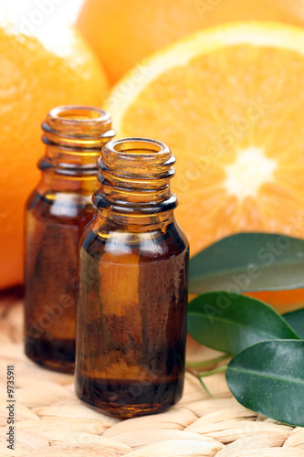 bottles of essential oils and some resh oranges