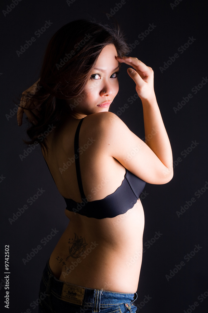 Fototapeta premium beautiful glamourous sensual asian woman in black bra and jeans