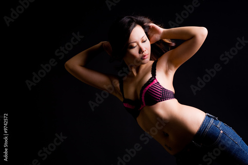 beautiful sensual asian woman in black bra and jeans © eyedear