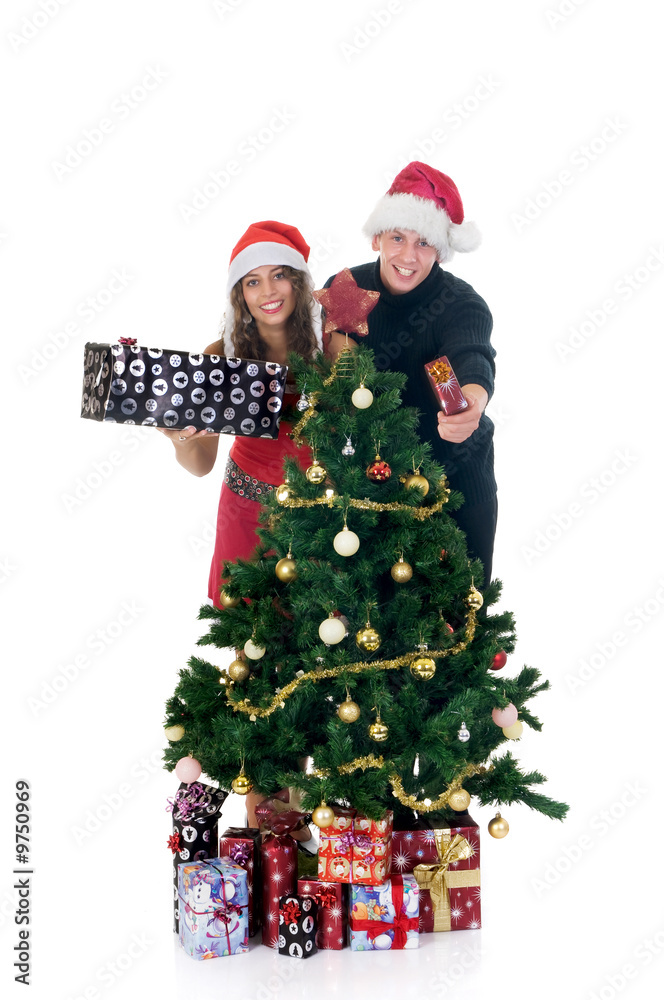 Christmas, happy couple next to Xmas tree with presents