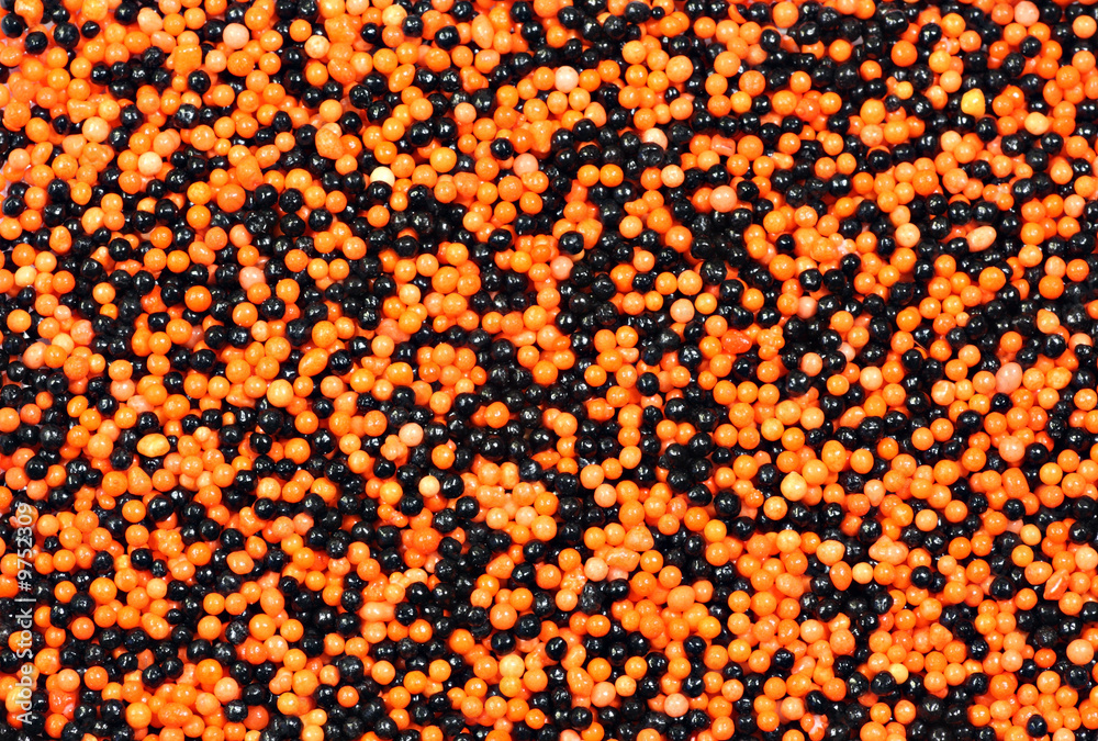 Obraz premium Background of orange and black candy sprinkles