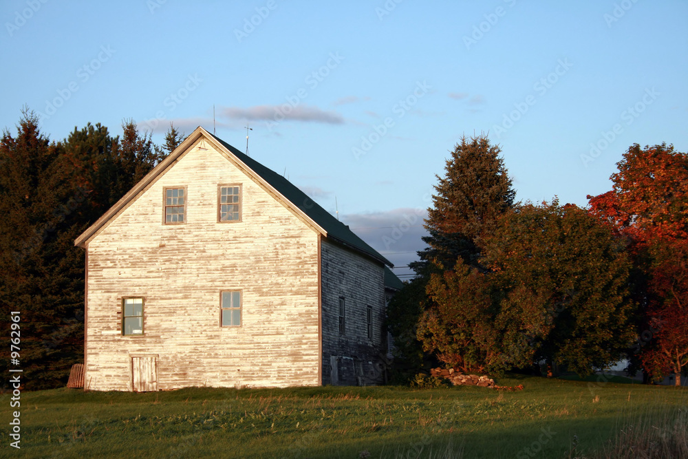 Old White Barn under Blue Sky in rural Maine