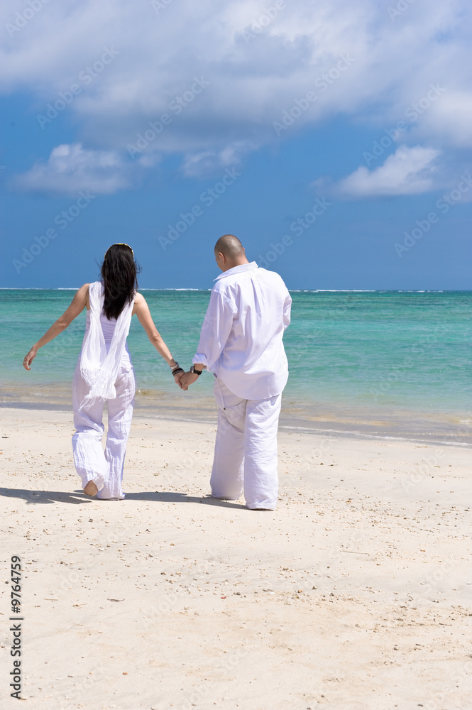 romantic couple walking on the beach
